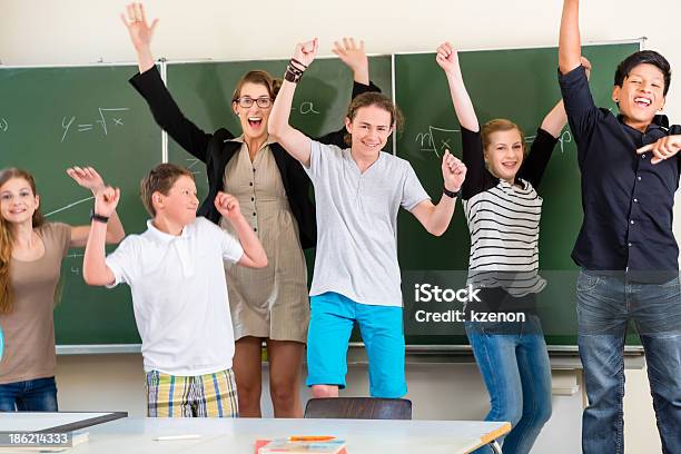 Teacher Motivating Students In School Class Stock Photo - Download Image Now - Student, School Building, Teacher