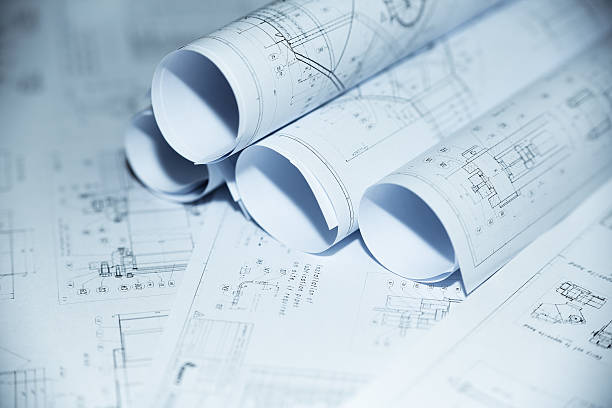 istock Rolled and spread out blueprint of a project 186214343