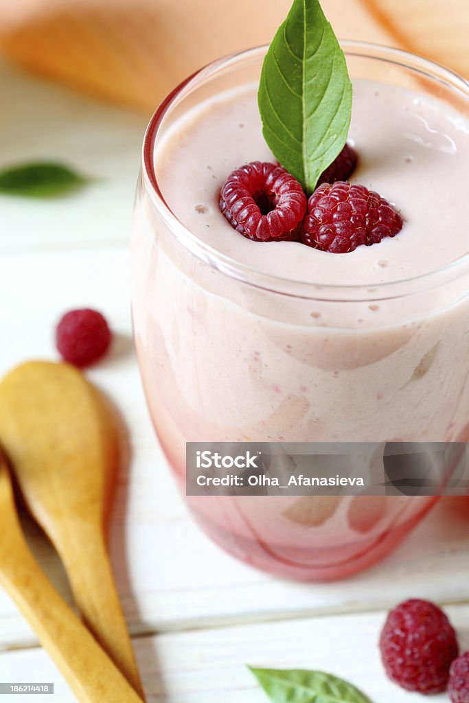 raspberry smoothie milk in a transparent glass raspberry smoothie milk in a transparent glass, close up Backgrounds Stock Photo