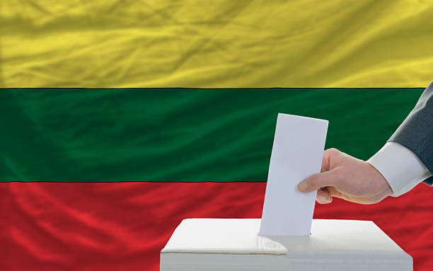 istock man voting on elections in lithuania front of flag 186215462