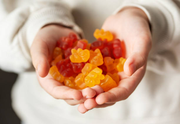 istock A girl holds a gummy bear vitamines in her hands 1862157389