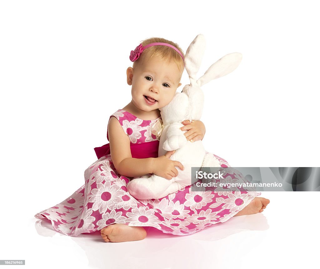 little baby girl hugging  toy bunny rabbit isolated on white little baby girl hugging a  toy bunny rabbit isolated on white background Adult Stock Photo