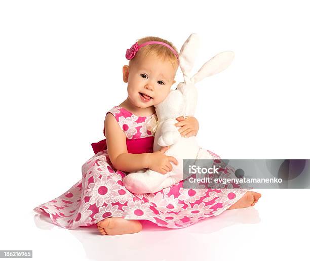 Little Baby Girl Hugging Toy Bunny Rabbit Isolated On White Stock Photo - Download Image Now