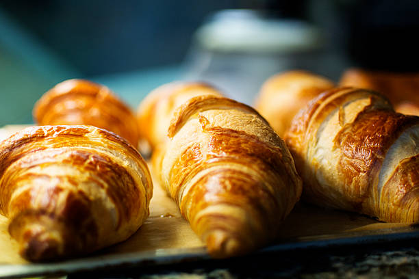 istock Baked croissants on a metal tray 186217406