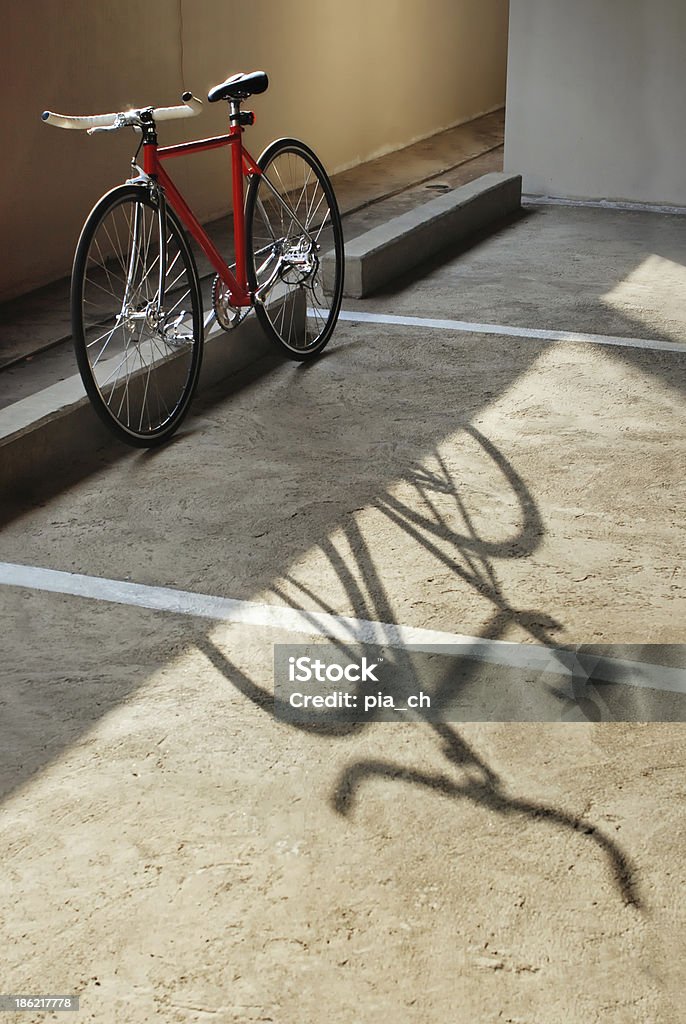Red bicycle and its shadow Single-speed or fixed gear bicycle standing in the parking lot Bicycle Stock Photo