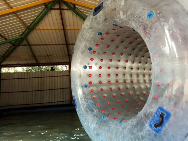 Photo of A closeup picture of a inflatable zorbing roller ball floating on water.