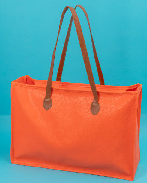 istock orange shopping bag, cyan background 1862191871