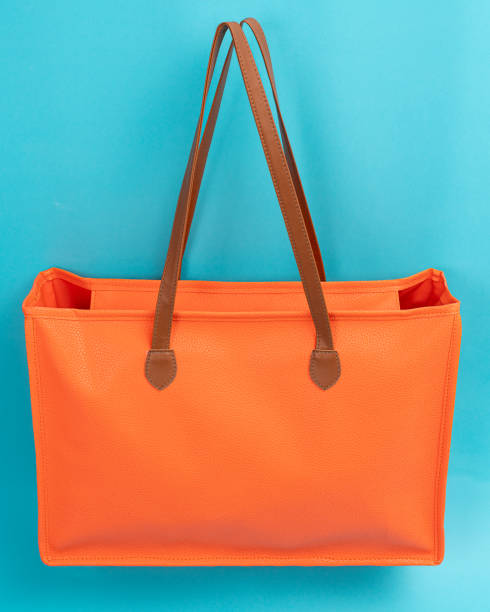 istock orange shopping bag, cyan background 1862191876