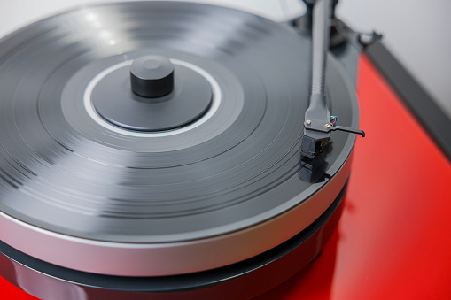 Close-up view of a vinyl record player with a vinyl disc playing.