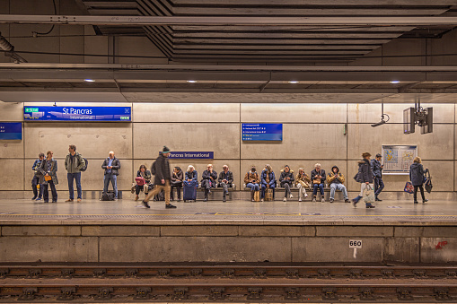 St Pancras Station, London, England - November 7th 2023:  People waiting on the modern railway station platform
