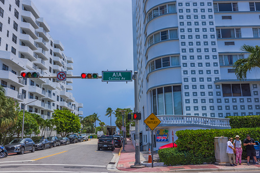 USA. Miami Beach. 12.17.2023. Urban landscape of one of the streets in Miami Beach with people standing at the intersection of Collins Avenue.