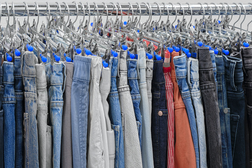 blue,  black and brown jeans denim trousers in a clothing store