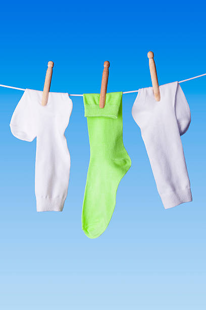 istock White and green socks on washing line 186221442