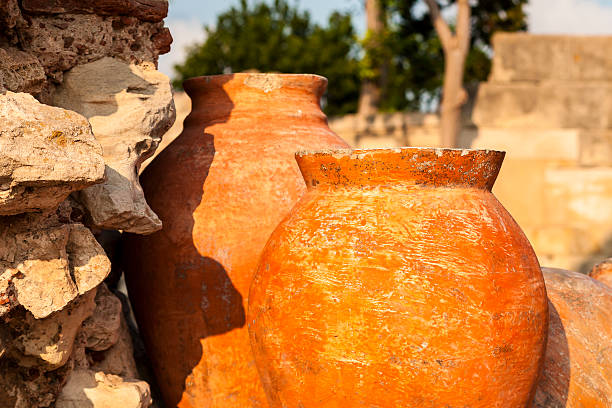 istock Terracotta, a clay amphora, stone wall in the background 186221667