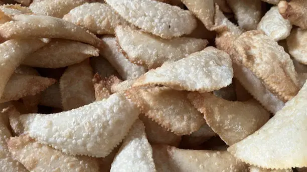 Karanji, also known as Gujiya in some regions, is a popular Indian sweet that features a crisp, flaky outer layer filled with a sweet and flavorful coconut stuffing.