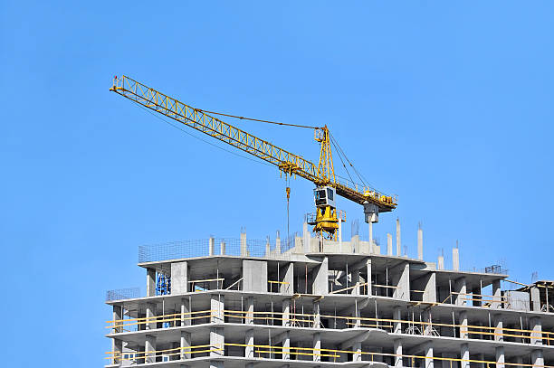 Crane and construction site Crane and building construction site against blue sky construction skyscraper machine industry stock pictures, royalty-free photos & images