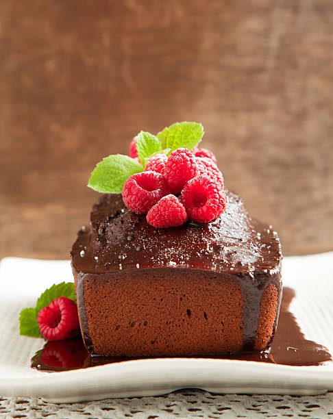 istock Chocolate loaf cake with frosting and raspberry 186223207