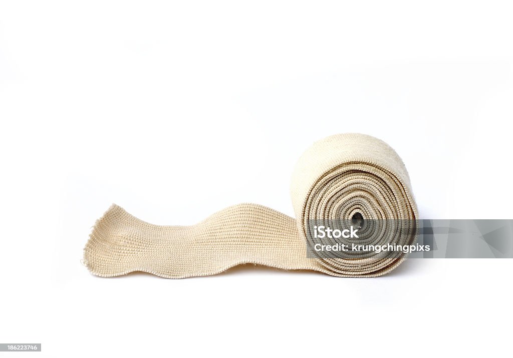 A rolled up medical bandage on a white bandage Medical bandage on a white background Rolled Up Stock Photo