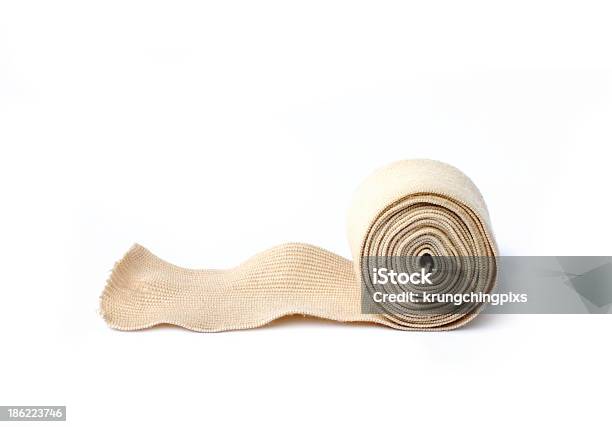 A Rolled Up Medical Bandage On A White Bandage Stock Photo - Download Image Now - Rolled Up, Bandage, Adhesive Bandage