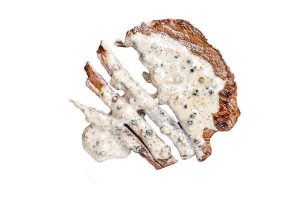 Roast fillet beef meat steak with peppercorn sauce on wooden board.   Isolated on white background.