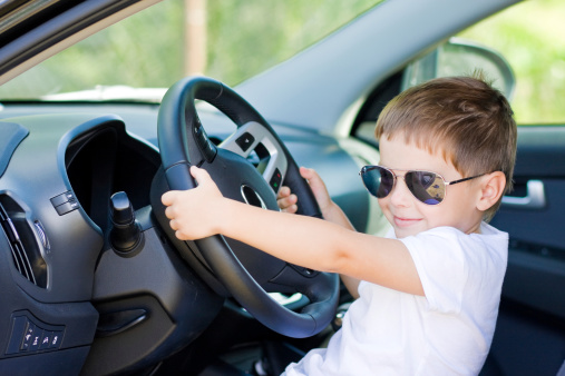 Cute driver шт sunglasses sits in car