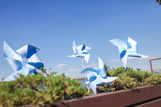 istock Toy windmills in a flowerpot with flowers 186227055