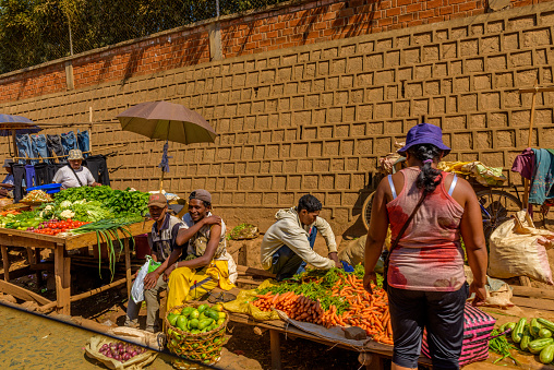 Ansirabe town, Madagascar, October 16, 2017: A group of vegetable vendors are seen selling produce by the roadside