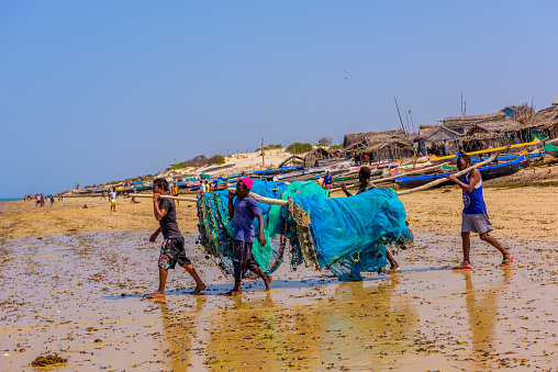 Fishermen's Village, Ifaty, Madagascar, October 21, 2017: A group of fishermen heading into the sea for fishing