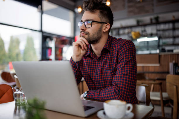 istock Worried young man working at a cafe 1862277860