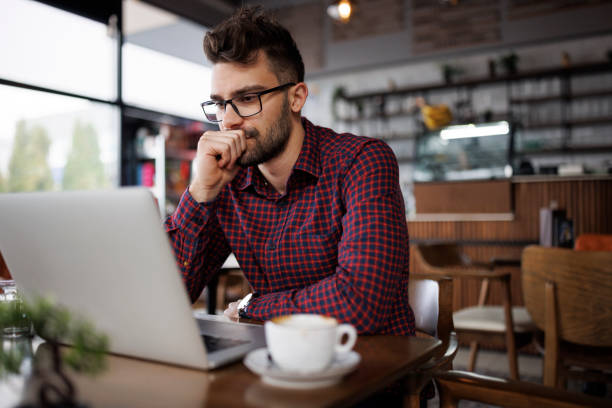 istock Worried young man working at a cafe 1862277881