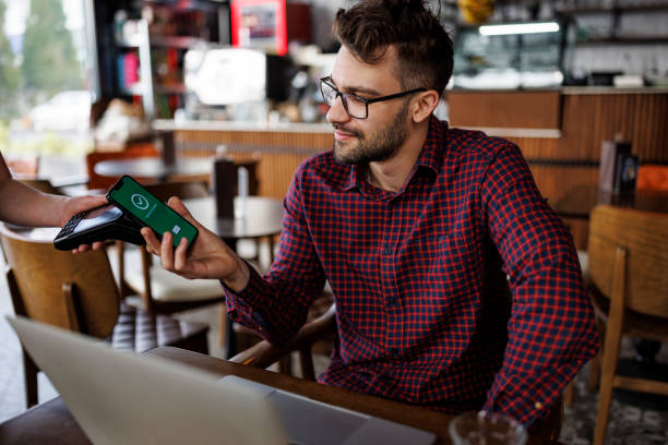 istock Young man paying for order at a cafe 1862277883