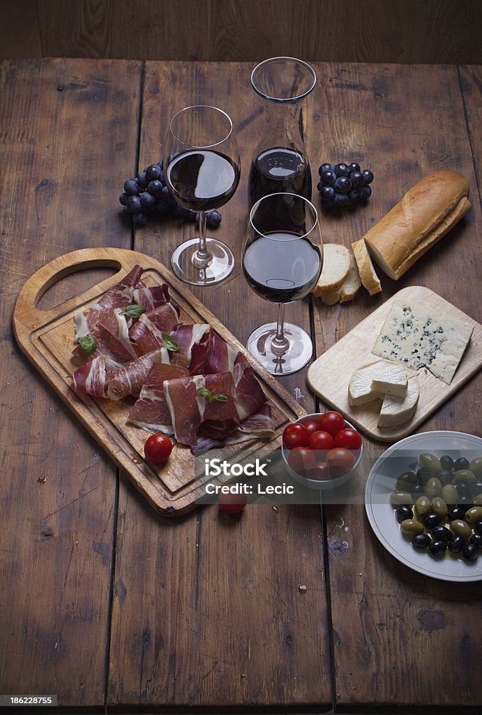 sliced prosciutto with red wine cheese and olives Appetizer Stock Photo