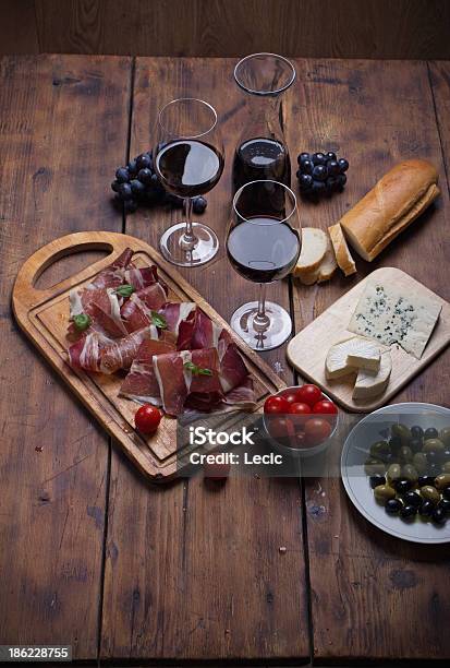 Sliced Prosciutto With Red Wine Cheese And Olives Stock Photo - Download Image Now - Appetizer, Bacon, Basil