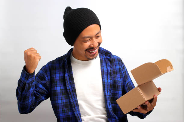 istock Asian man unpacks the cardboard parcel package 1862296878