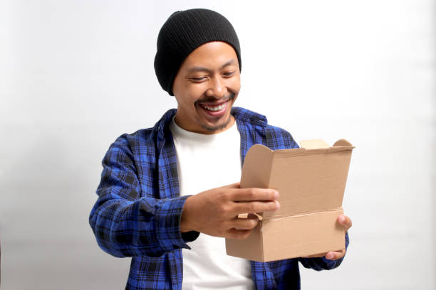 istock Asian man unpacks the cardboard parcel package 1862298954