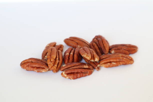 istock Pile of pecan nuts isolated over the white background 1862299428