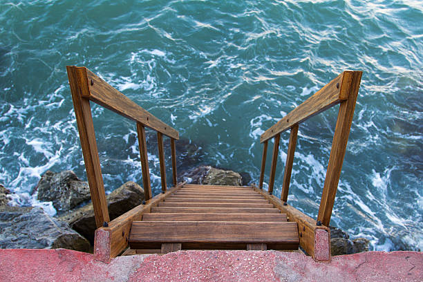 Wavy sea and stairs at the coast.