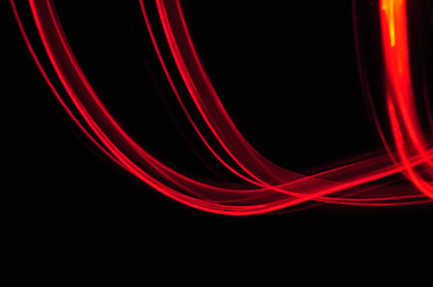 istock red orange lines trace on black background 186233051
