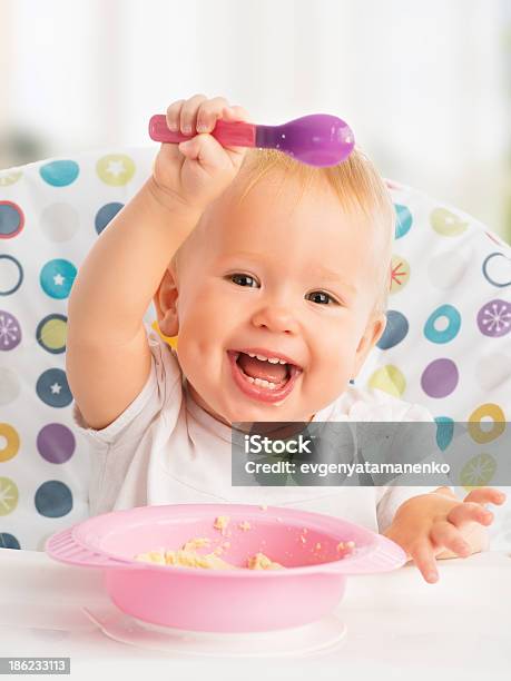 Happy Baby Child Eats Itself With A Spoon Stock Photo - Download Image Now - Baby - Human Age, Food, Spoon