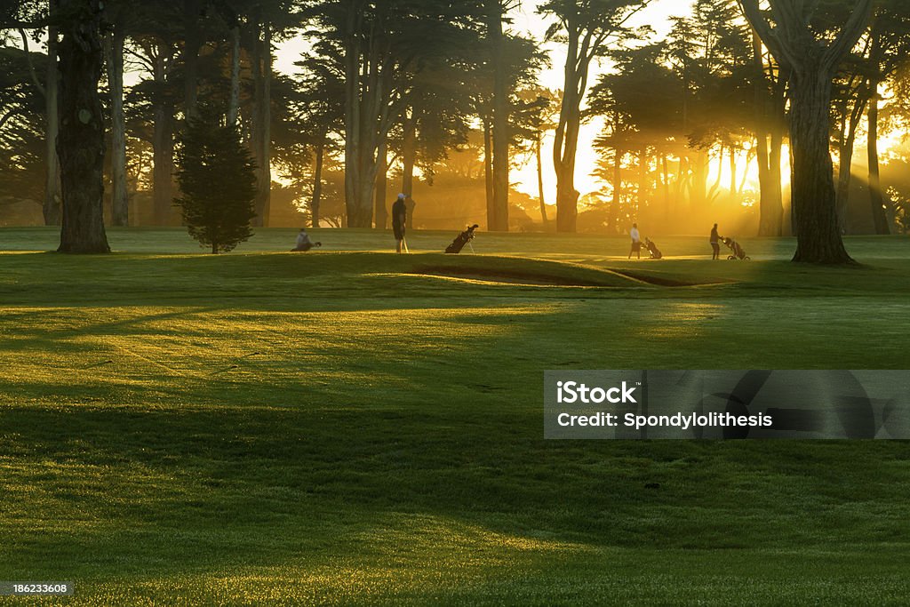 Sunrise in misty galf course Golfer Stock Photo