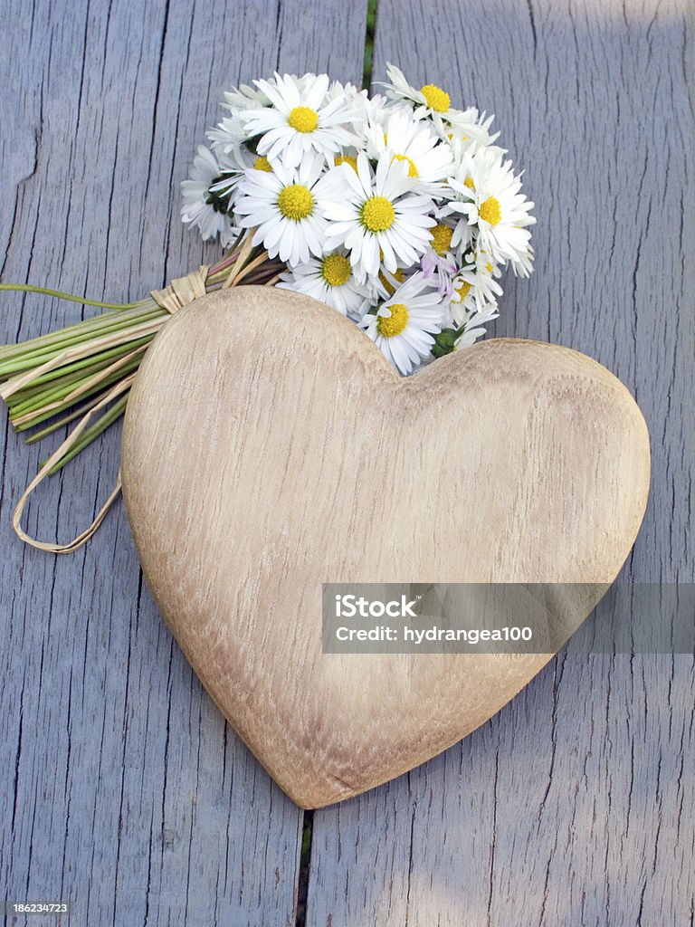 heart and daisies Wooden heart and a bouquet of daisies Birthday Stock Photo