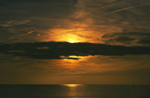 Sunset beach landscape with golden hues.