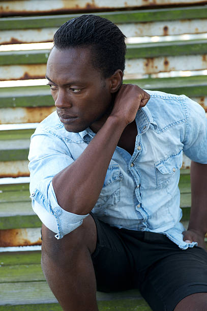 istock Handsome black male model sitting outdoors 186235067