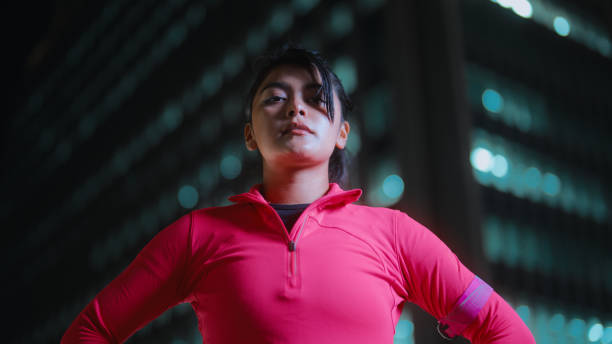 Portrait of beautiful multi-racial female athlete in city at night A portrait of a beautiful multi-racial female athlete in a city at night. low angle street japan stock pictures, royalty-free photos & images