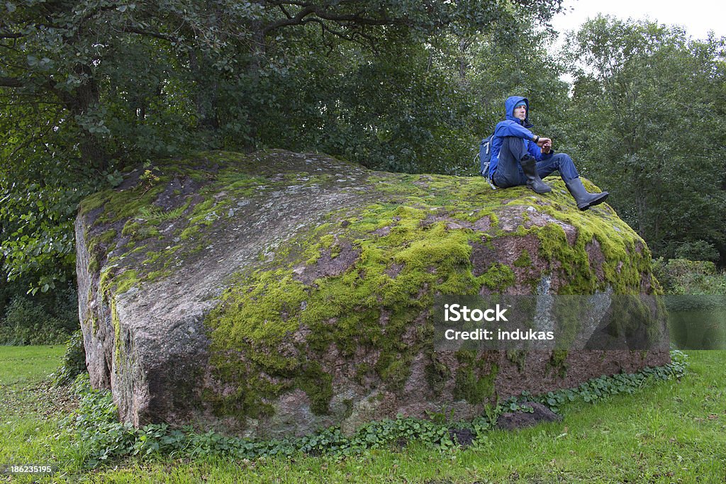 Hiker resting on big stone Blue Stock Photo