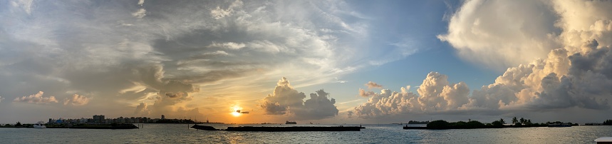 Panoramic view of a beautiful tropical sunset seen from a pier in Maldives