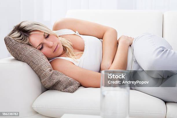 Woman With Stomach Ache Stock Photo - Download Image Now - Abdomen, Adult, Beautiful People