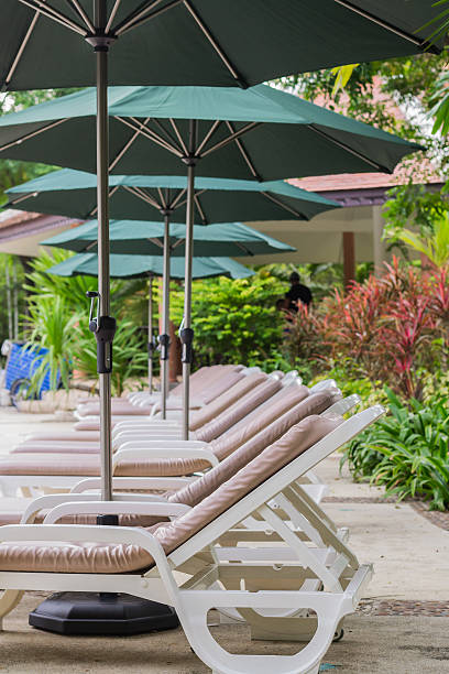 istock couches with umbrellas around the pool 186240096