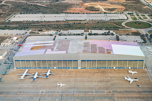 Large hangar and planes at the airport.
