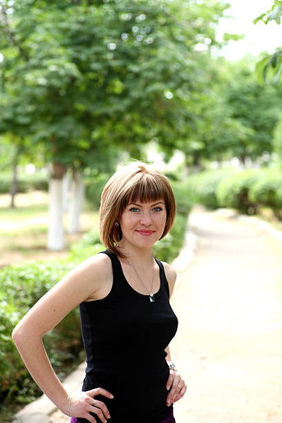 istock The young smiling woman in park. 186243817
